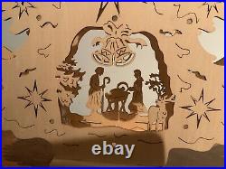 Christmas nativity scene In Wood Under A Decorated Christmas Tree Led Lights